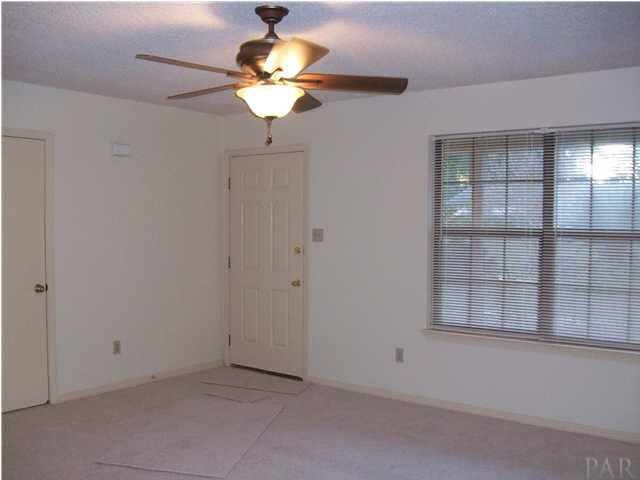 6640 Bellview Pines Road Pensacola, FL 32526 - Photo 9 of 22 Livingroom has new carpert and ceiling fan, just painted!!!