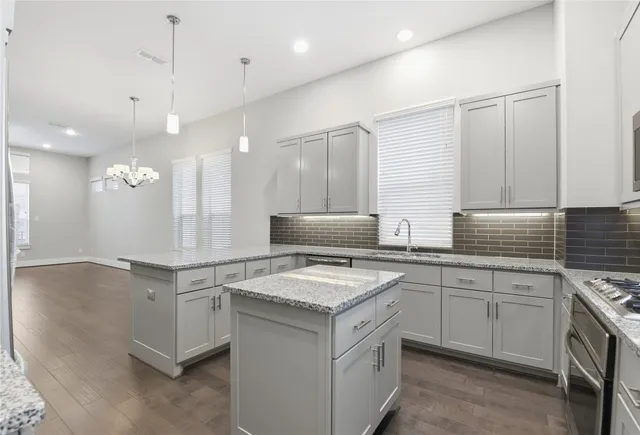 a kitchen with a sink stove and cabinets