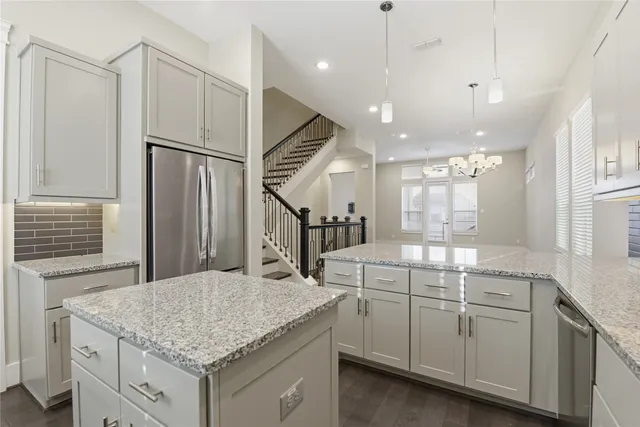 a kitchen with a sink a counter space appliances and a cabinets