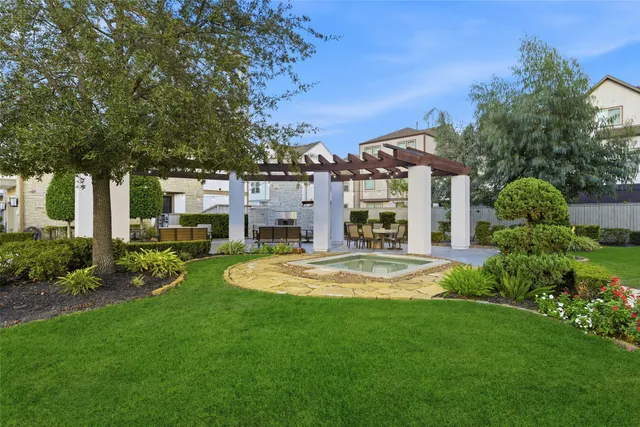 a view of a house with swimming pool and sitting area