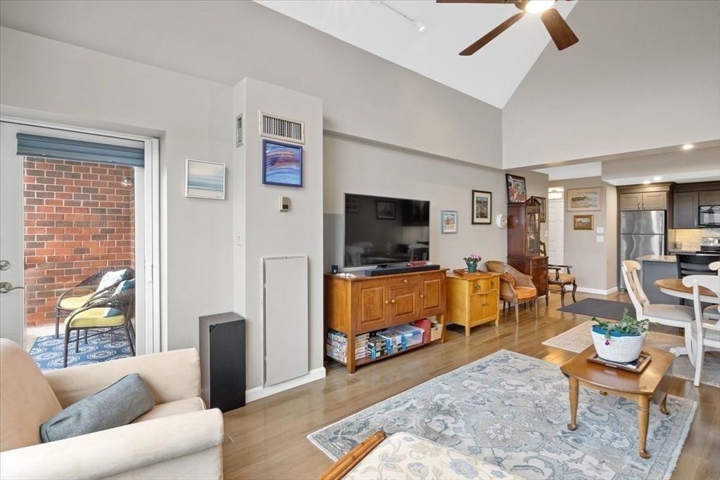 155 George Washington Boulevard, Unit 707 Hull, MA 02045 - Photo 11 of 24 a living room with furniture and a flat screen tv