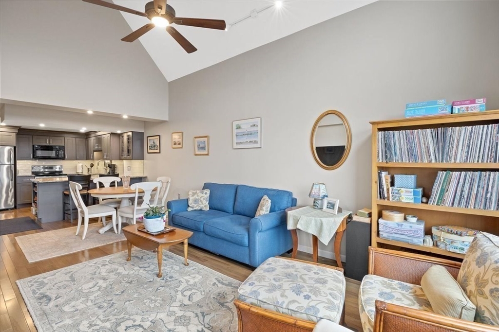 155 George Washington Boulevard, Unit 707 Hull, MA 02045 - Photo 13 of 24 a living room with furniture and a book shelf