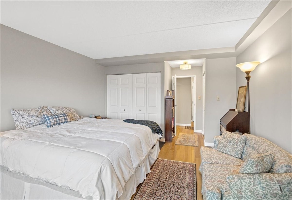 155 George Washington Boulevard, Unit 707 Hull, MA 02045 - Photo 14 of 24 a bedroom with a bed and a couch