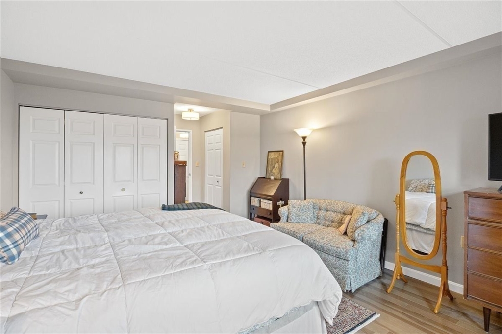 155 George Washington Boulevard, Unit 707 Hull, MA 02045 - Photo 15 of 24 a bedroom with a bed and a large window