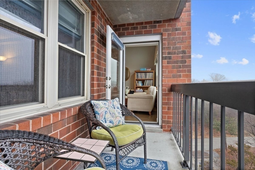 155 George Washington Boulevard, Unit 707 Hull, MA 02045 - Photo 18 of 24 a view of a chair and tables in the balcony