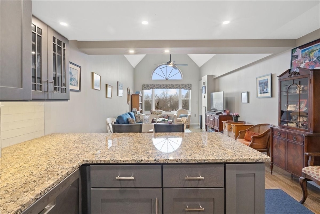 155 George Washington Boulevard, Unit 707 Hull, MA 02045 - Photo 6 of 24 a kitchen with granite countertop kitchen island sink stove and cabinets