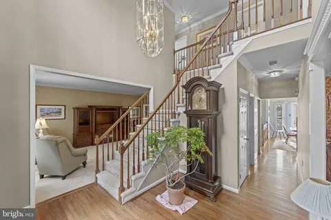 a view of entryway livingroom and hall with wooden floor