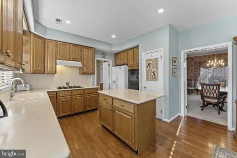 a kitchen with granite countertop a sink stove and refrigerator