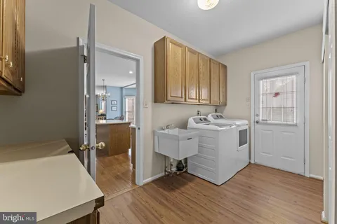 a view of a hallway with washer and dryer