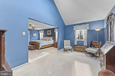 a bedroom with furniture and a chair