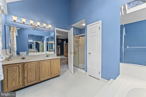 a large bathroom with a large tub and sink