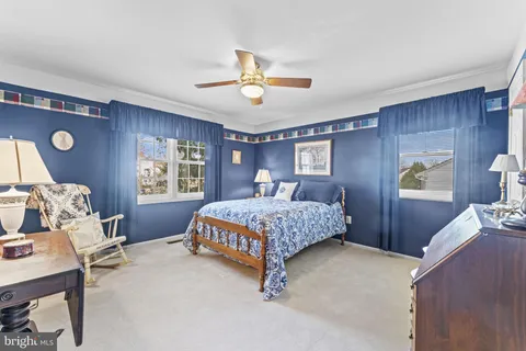 a bedroom with a bed mirror and window