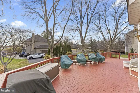 a view of a patio with couches and table and chairs and potted plants
