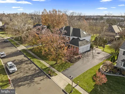 an aerial view of a house with a yard and lake view