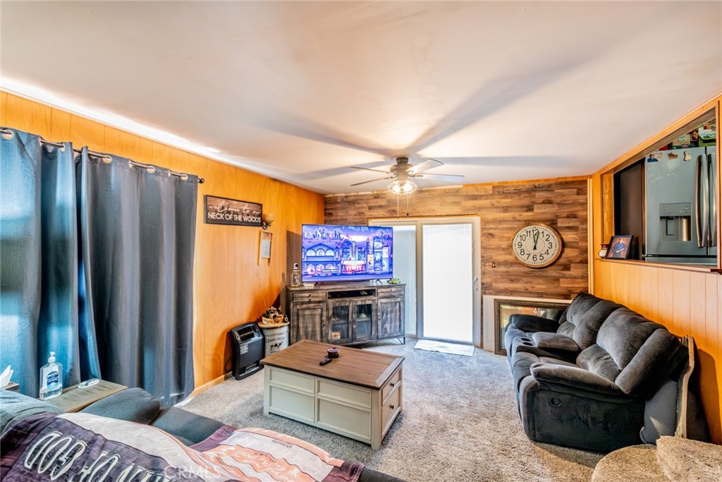 52647 Pine Cove Road Idyllwild, CA 92549 - Photo 14 of 35 a living room with furniture a fireplace and a large window