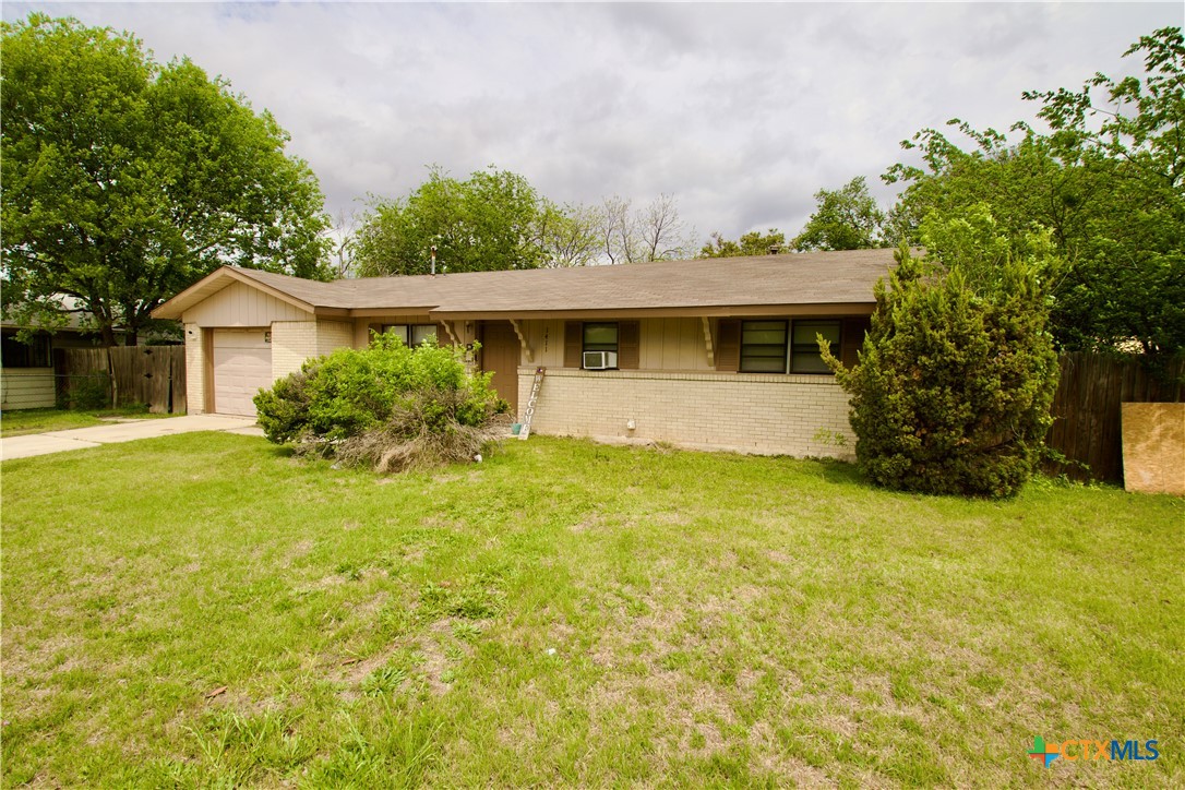 1411 West Lane Killeen, TX 76549 - Photo 1 of 36 a front view of a house with garden