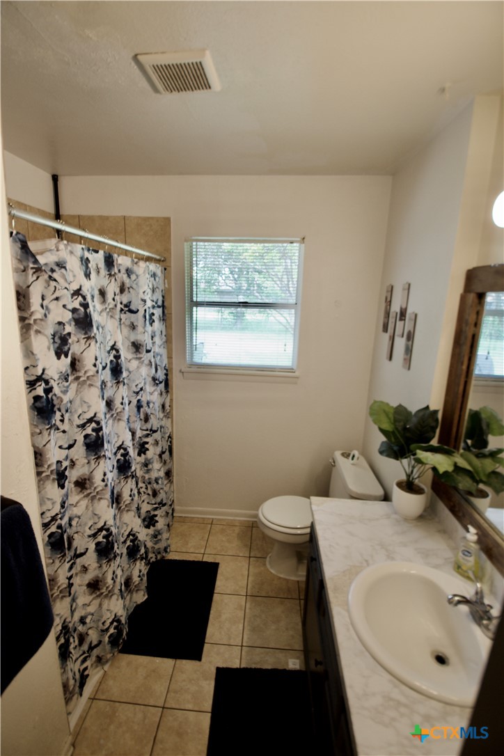 1411 West Lane Killeen, TX 76549 - Photo 15 of 36 a bathroom with a sink toilet and shower