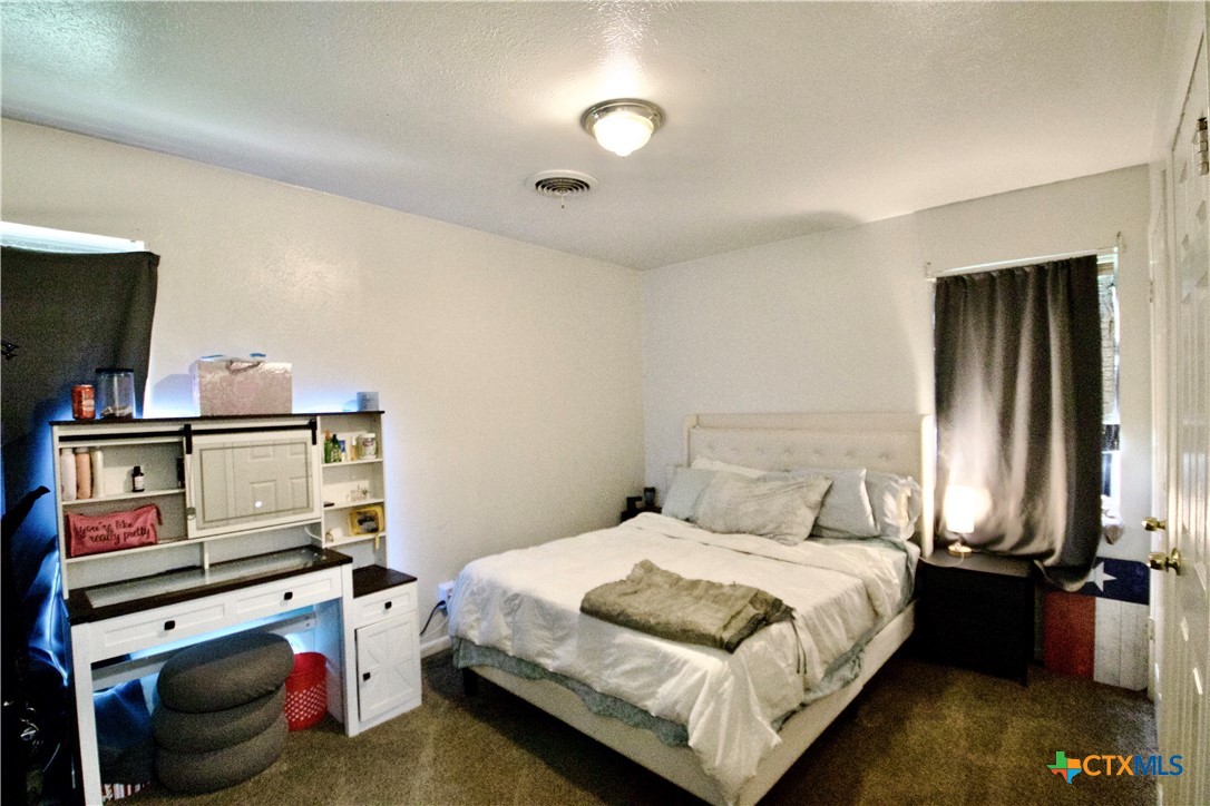 1411 West Lane Killeen, TX 76549 - Photo 17 of 36 a bedroom with a bed and a book shelf