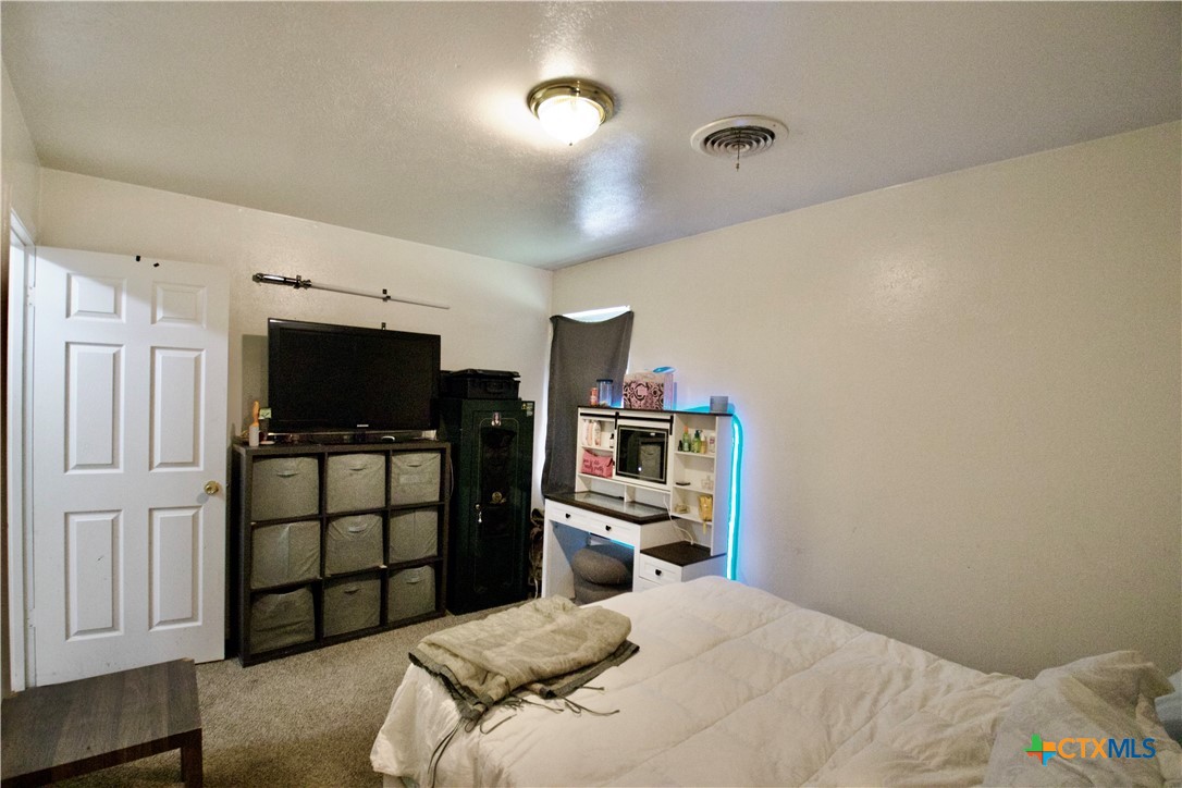 1411 West Lane Killeen, TX 76549 - Photo 18 of 36 a bedroom with a bed and a flat screen tv