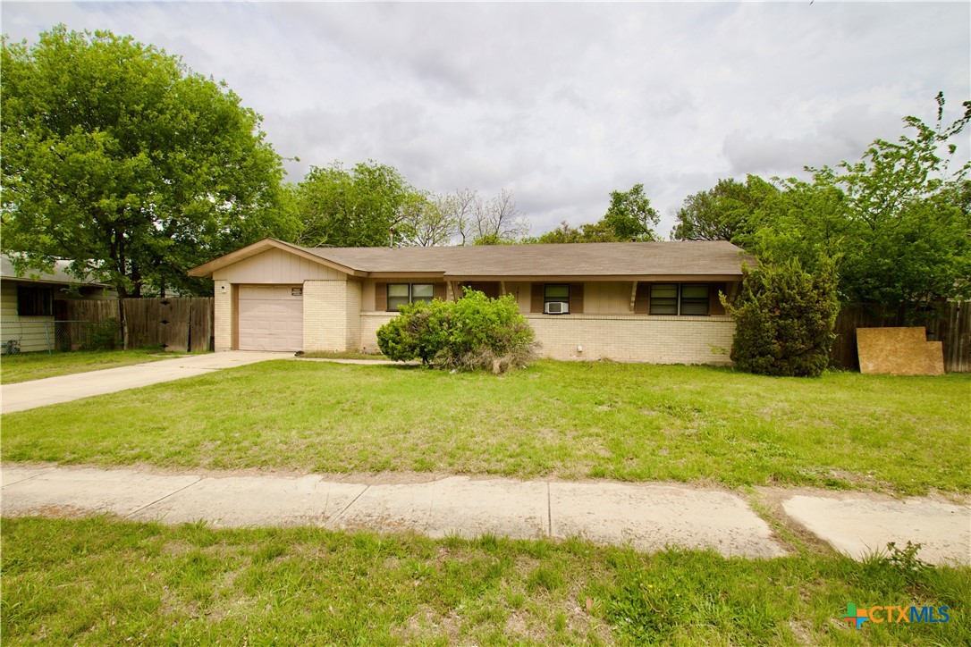 1411 West Lane Killeen, TX 76549 - Photo 2 of 36 a front view of a house with garden