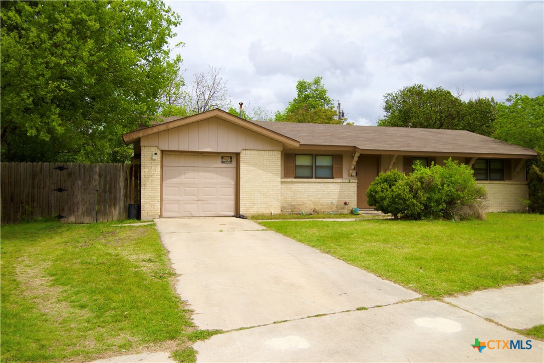 1411 West Lane Killeen, TX 76549 - Photo 3 of 36 a front view of a house with garden