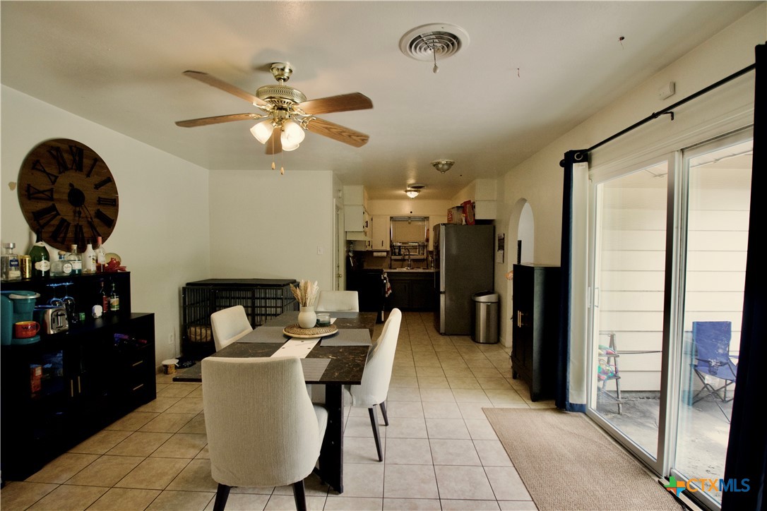 1411 West Lane Killeen, TX 76549 - Photo 7 of 36 a dining room with furniture and a chandelier fan