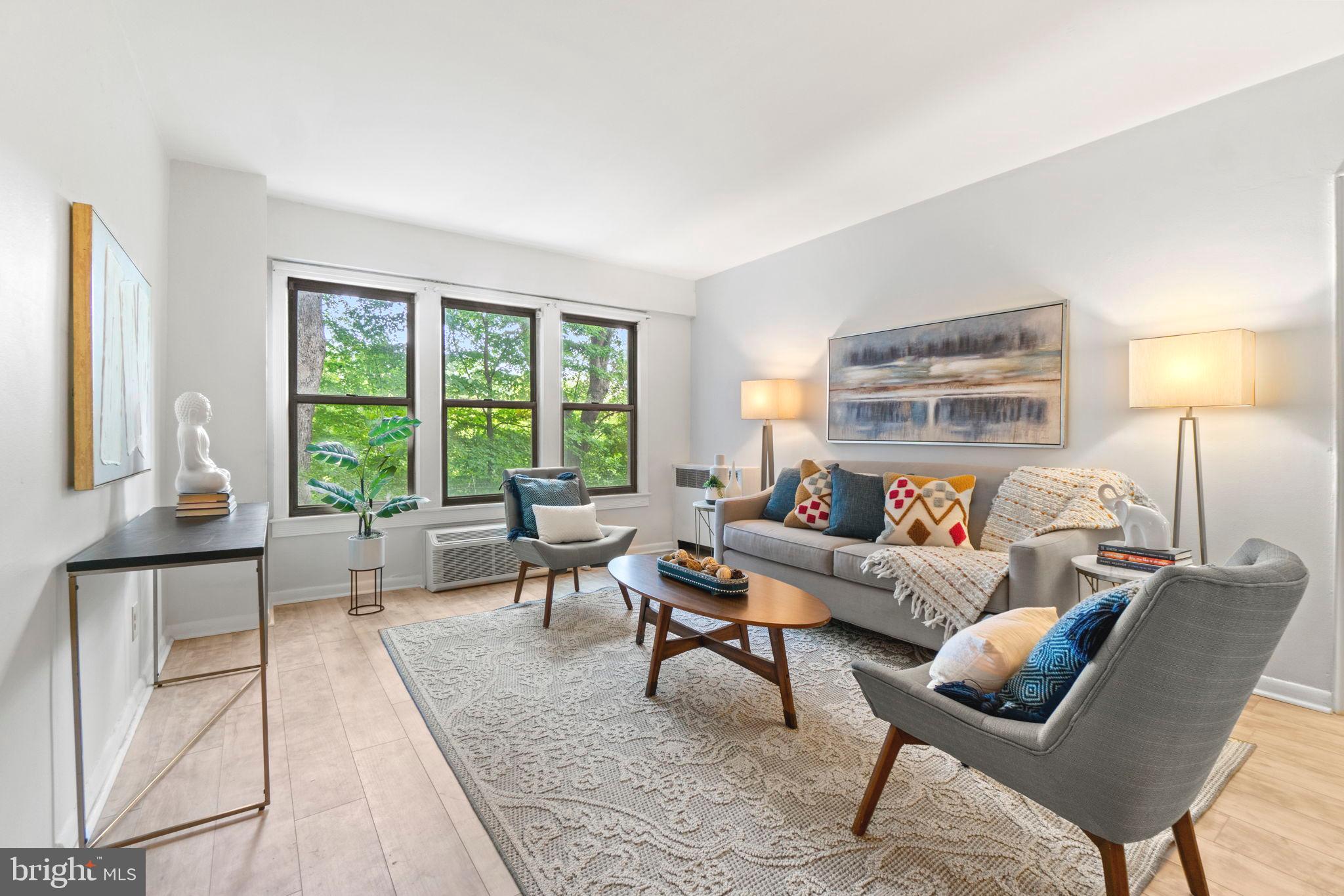 2500 Q Street Northwest, Unit 206 Washington, DC 20007 - Photo 2 of 21 a living room with furniture and a large window