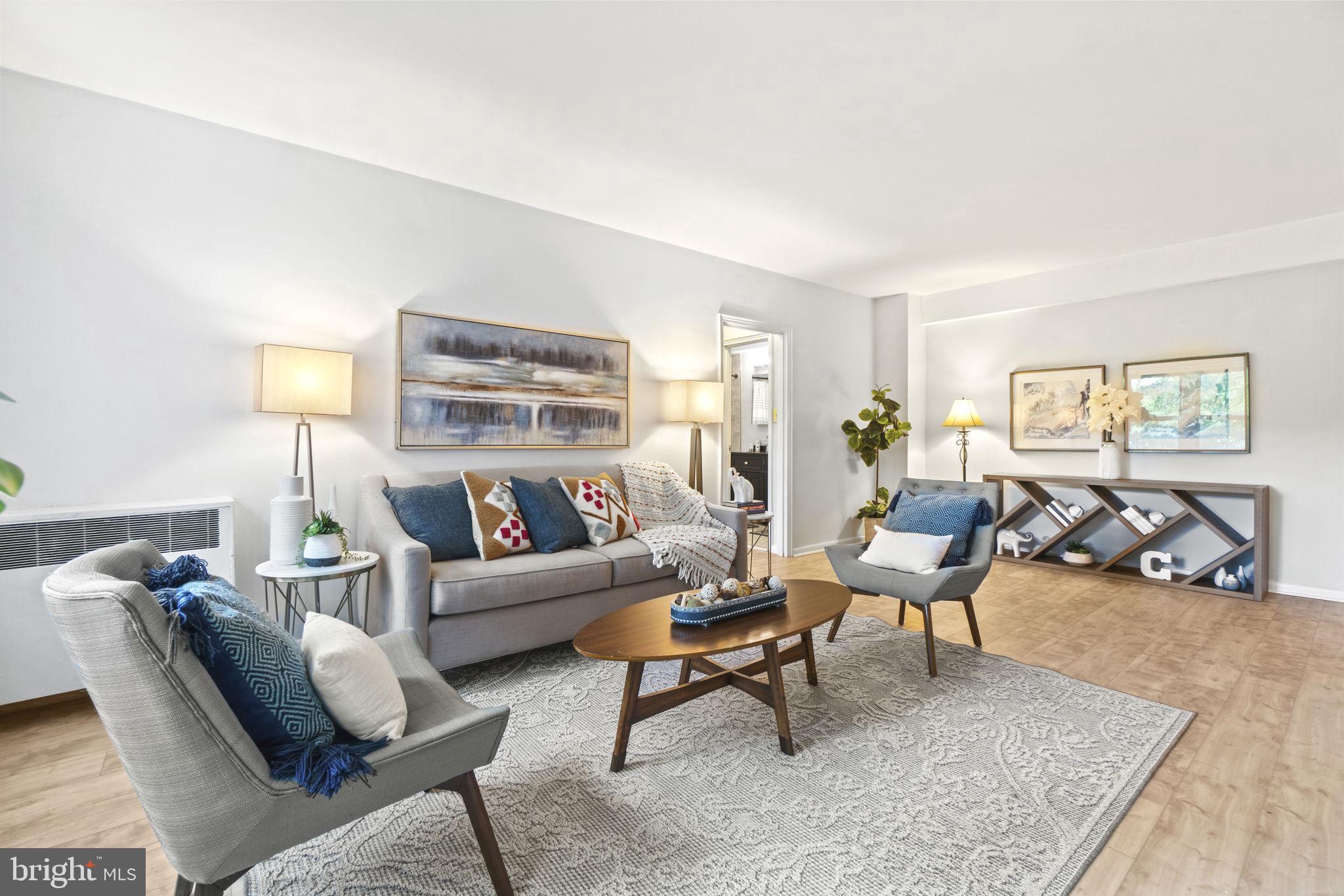 2500 Q Street Northwest, Unit 206 Washington, DC 20007 - Photo 3 of 21 a living room with furniture a rug and a table