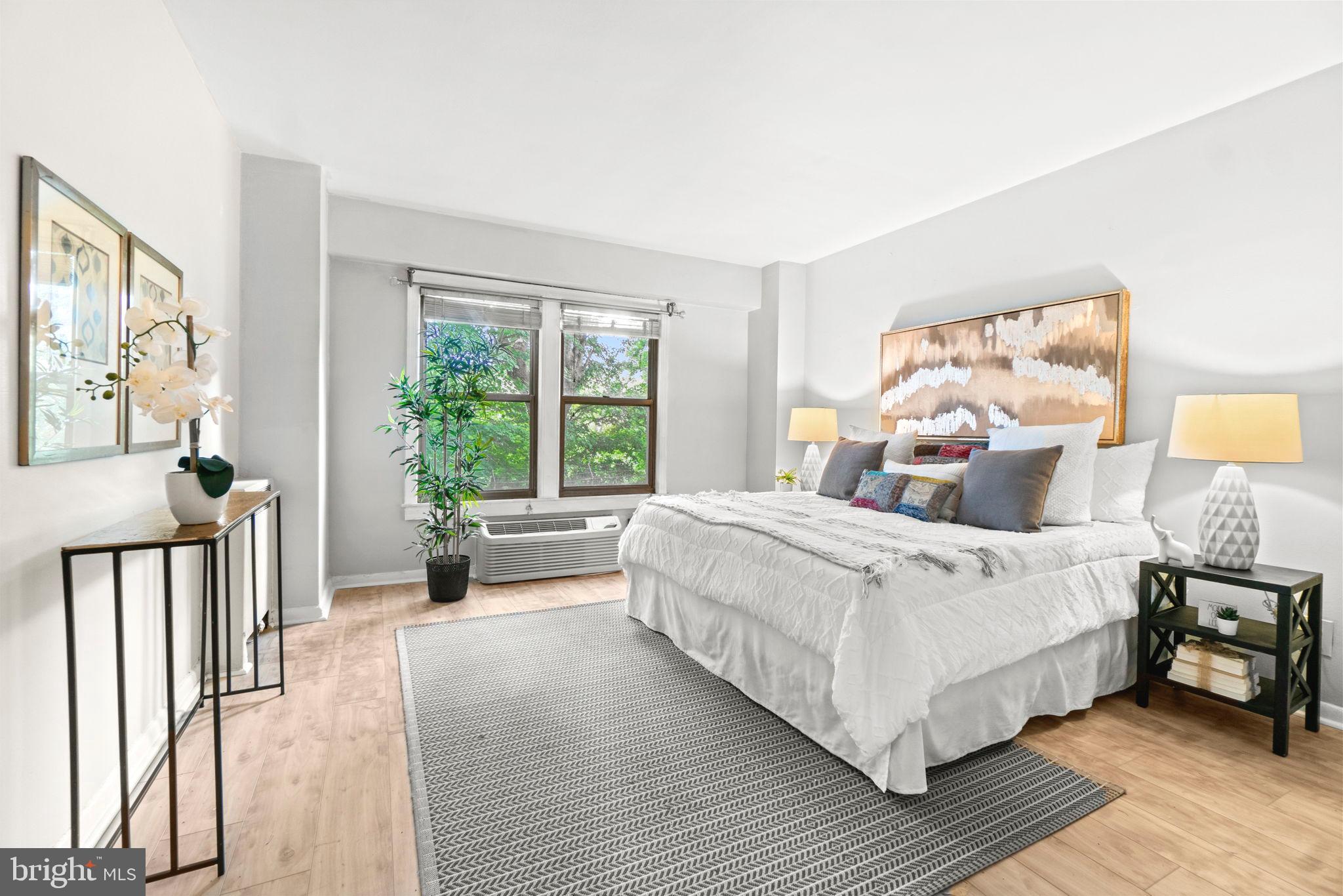 2500 Q Street Northwest, Unit 206 Washington, DC 20007 - Photo 5 of 21 a bedroom with a bed and a large window