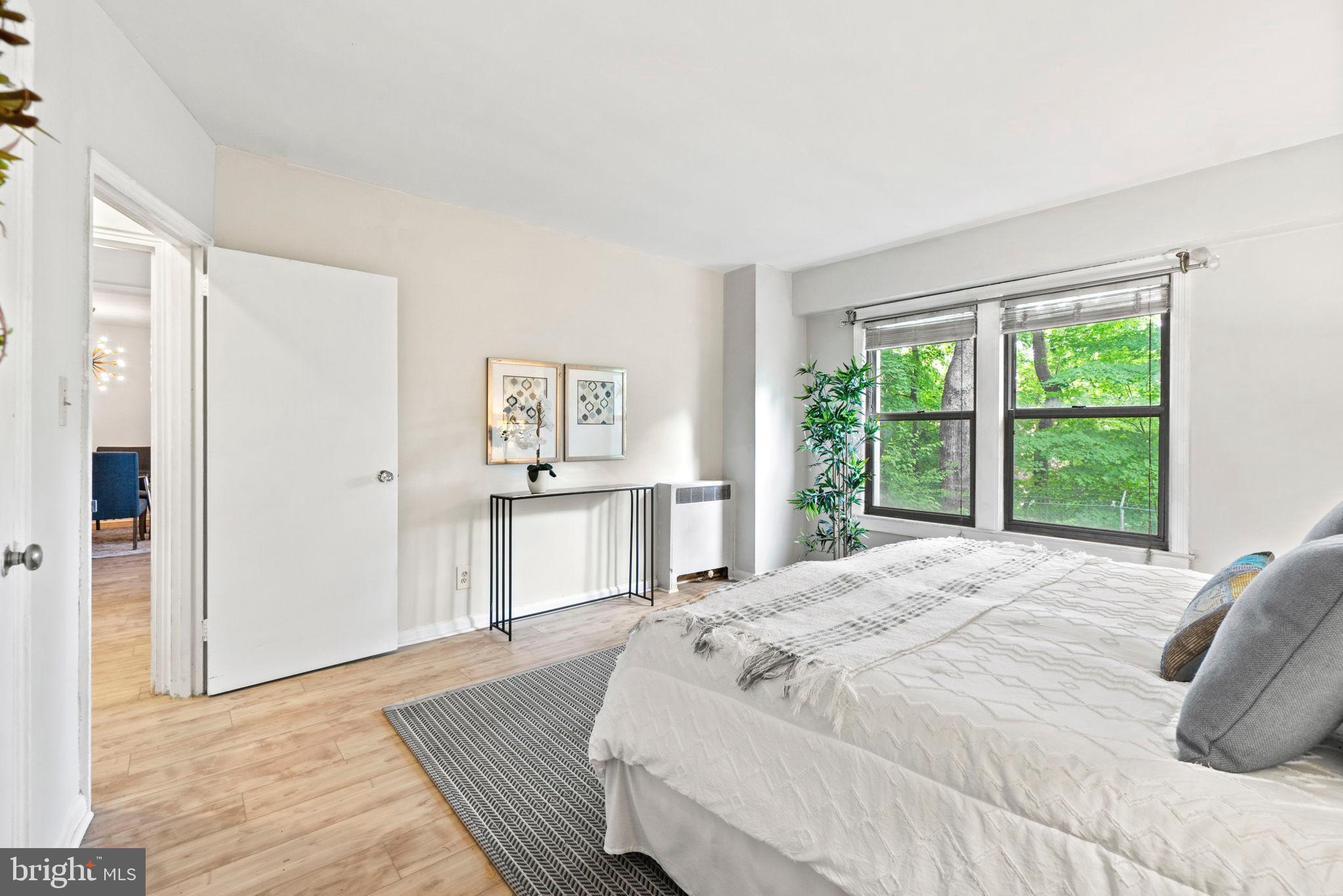 2500 Q Street Northwest, Unit 206 Washington, DC 20007 - Photo 6 of 21 a spacious bedroom with a bed and a window