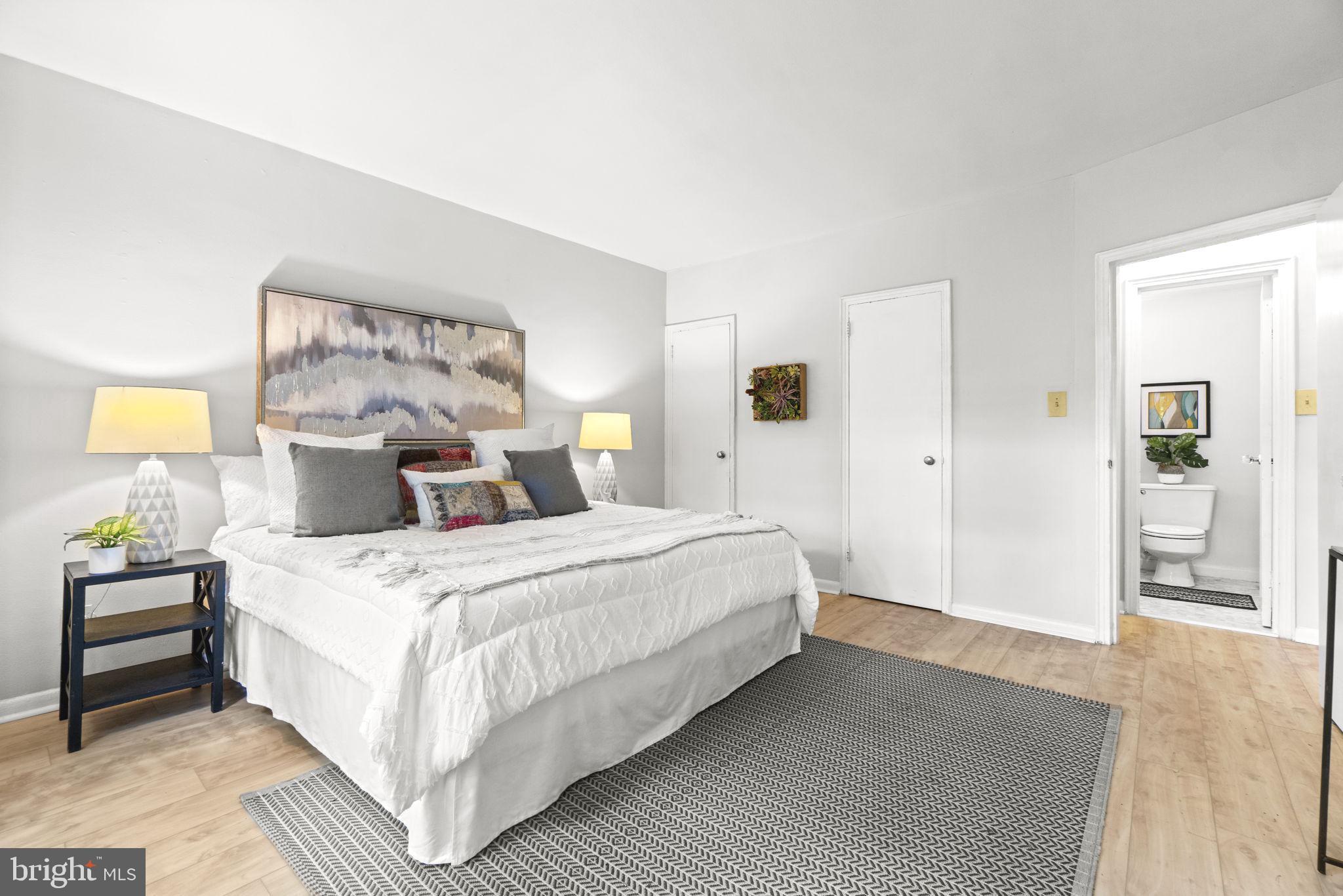 2500 Q Street Northwest, Unit 206 Washington, DC 20007 - Photo 7 of 21 a bedroom with a bed and wooden floor