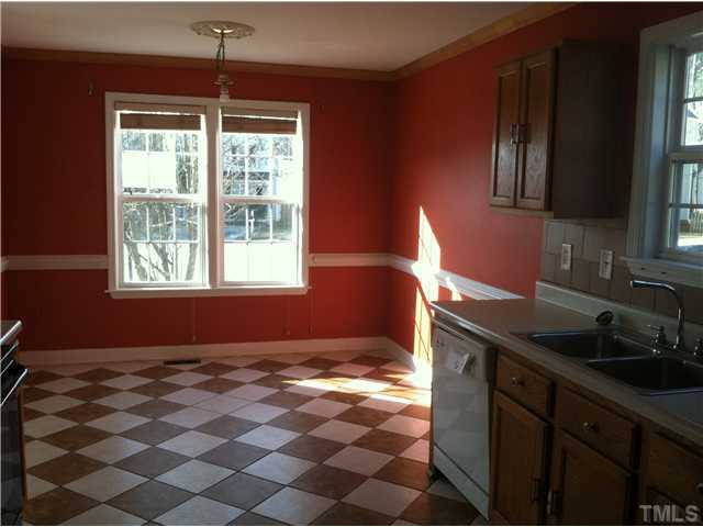 4516 Archibald Way Raleigh, NC 27616 - Photo 3 of 7 a kitchen with a sink a window and cabinets