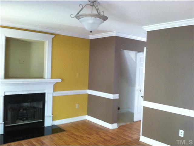 4516 Archibald Way Raleigh, NC 27616 - Photo 4 of 7 a view of livingroom with kitchen and fireplace