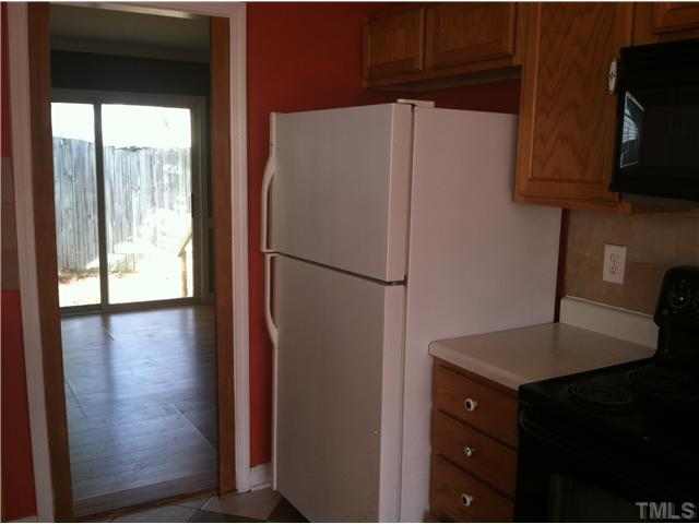 4516 Archibald Way Raleigh, NC 27616 - Photo 6 of 7 a white refrigerator freezer and a wooden floor