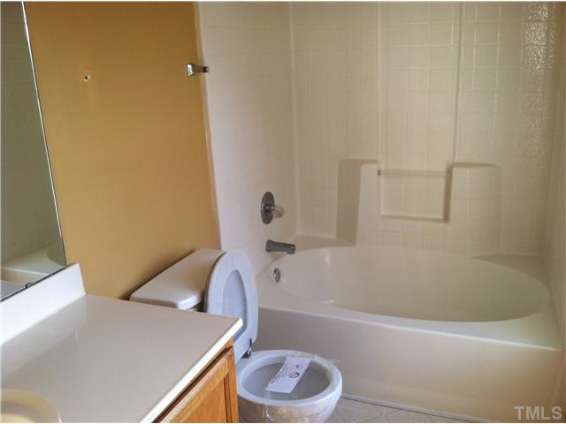 4516 Archibald Way Raleigh, NC 27616 - Photo 7 of 7 a bathroom with a sink a toilet and bathtub
