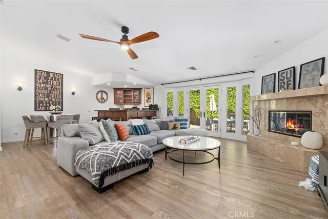 a living room with furniture a fireplace and a large window