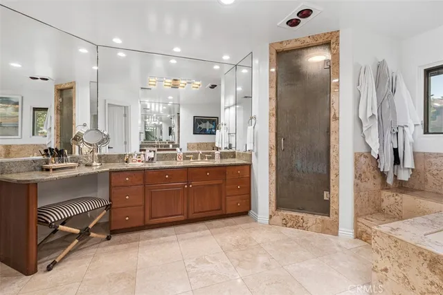 a spacious bathroom with a tub sink and mirror
