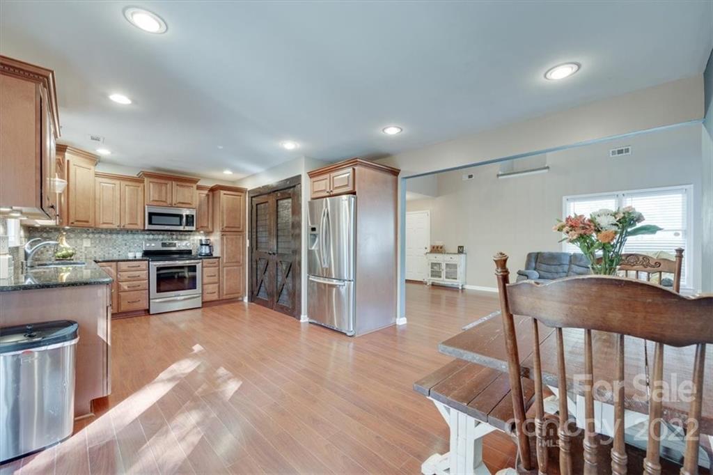100 Banksridge Road Fort Mill, SC 29715 - Photo 6 of 27 a kitchen with counter top space cabinets and stainless steel appliances