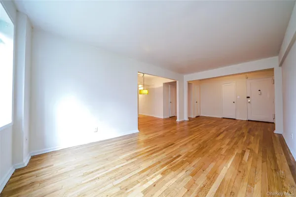 an empty room with wooden floor