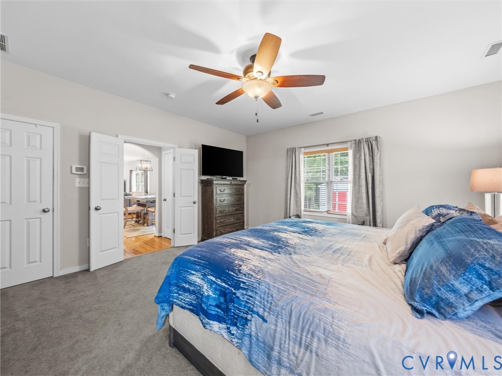 10824 Avening Road Chesterfield, VA 23832 - Photo 23 of 47 a bedroom with a bed and a chandelier