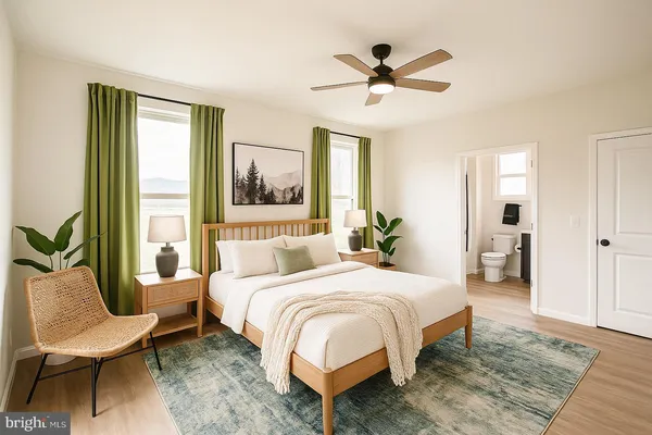 a bedroom with a bed and a potted plant