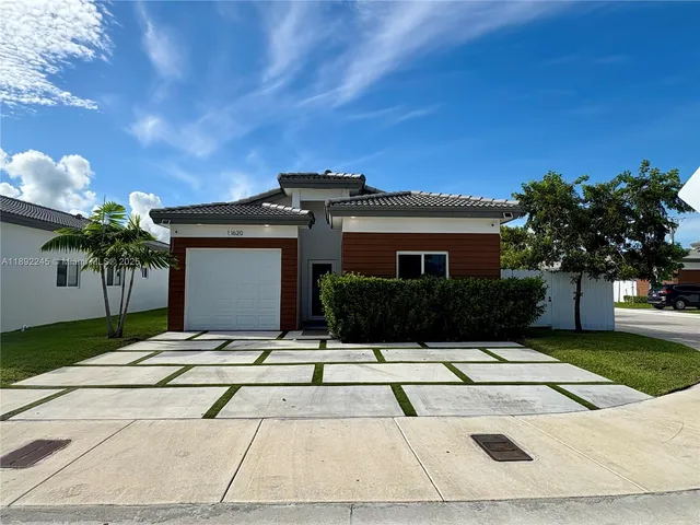 a view of white house with a yard