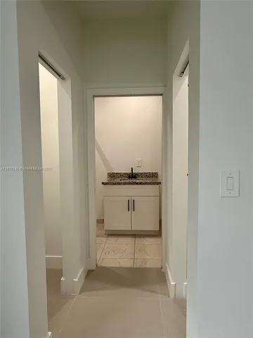 a view of kitchen with white cabinets