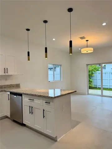 a kitchen with a sink and a window