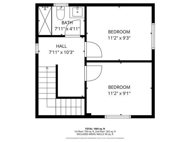 an empty room with wooden floor and mirror