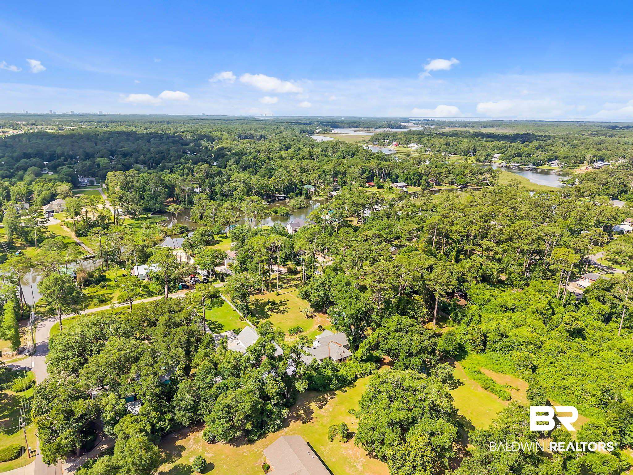 7189 Helton Drive Foley, AL 36535 - Photo 96 of 99 Aerial view of a nearby body of water and a forest