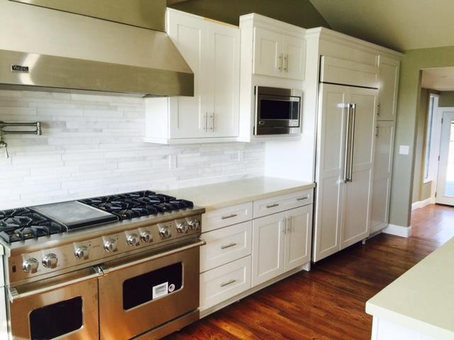 2777 Pradera Road Carmel, CA 93923 - Photo 3 of 8 a kitchen with stainless steel appliances white cabinets and wooden floor