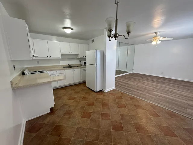 a kitchen with kitchen island a counter top space appliances and cabinets