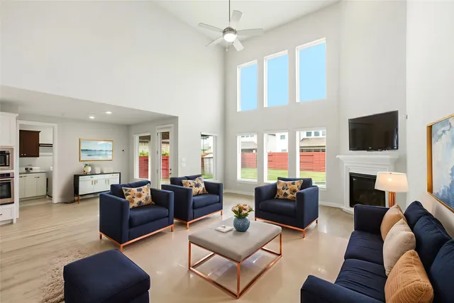 a living room with furniture a fireplace and a flat screen tv