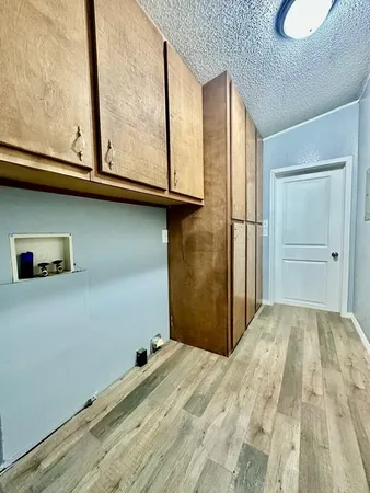 a view of a room with wooden floor